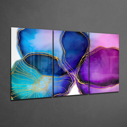 Three glass panels with abstract golden line designs on blue, purple, and pink gradient backgrounds displayed on gray wall.