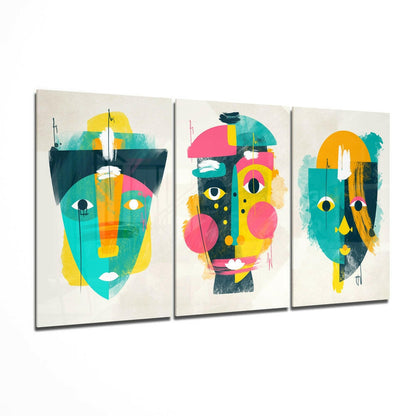 Three glass canvas panels displaying colorful abstract faces with geometric shapes in teal, yellow, pink, and orange on cream backgrounds.