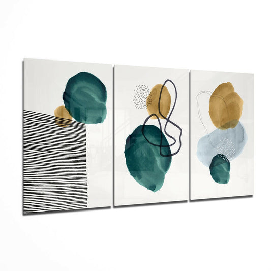 Three-panel glass wall art displaying abstract watercolor shapes in teal, gold, and blue with black line drawings and dotted details.