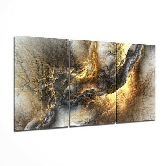 Three-panel triptych glass wall art displaying abstract golden and gray swirling patterns with metallic finishes.