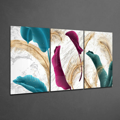 Three-panel glass wall art displaying teal, magenta, and teal stylized leaves with gold botanical details on white textured background, mounted on gray wall.