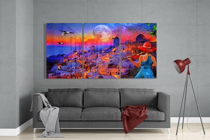 Three-panel glass wall art depicting a colorful sunset coastal village scene with a woman playing violin, displayed above a gray sofa in a modern interior.