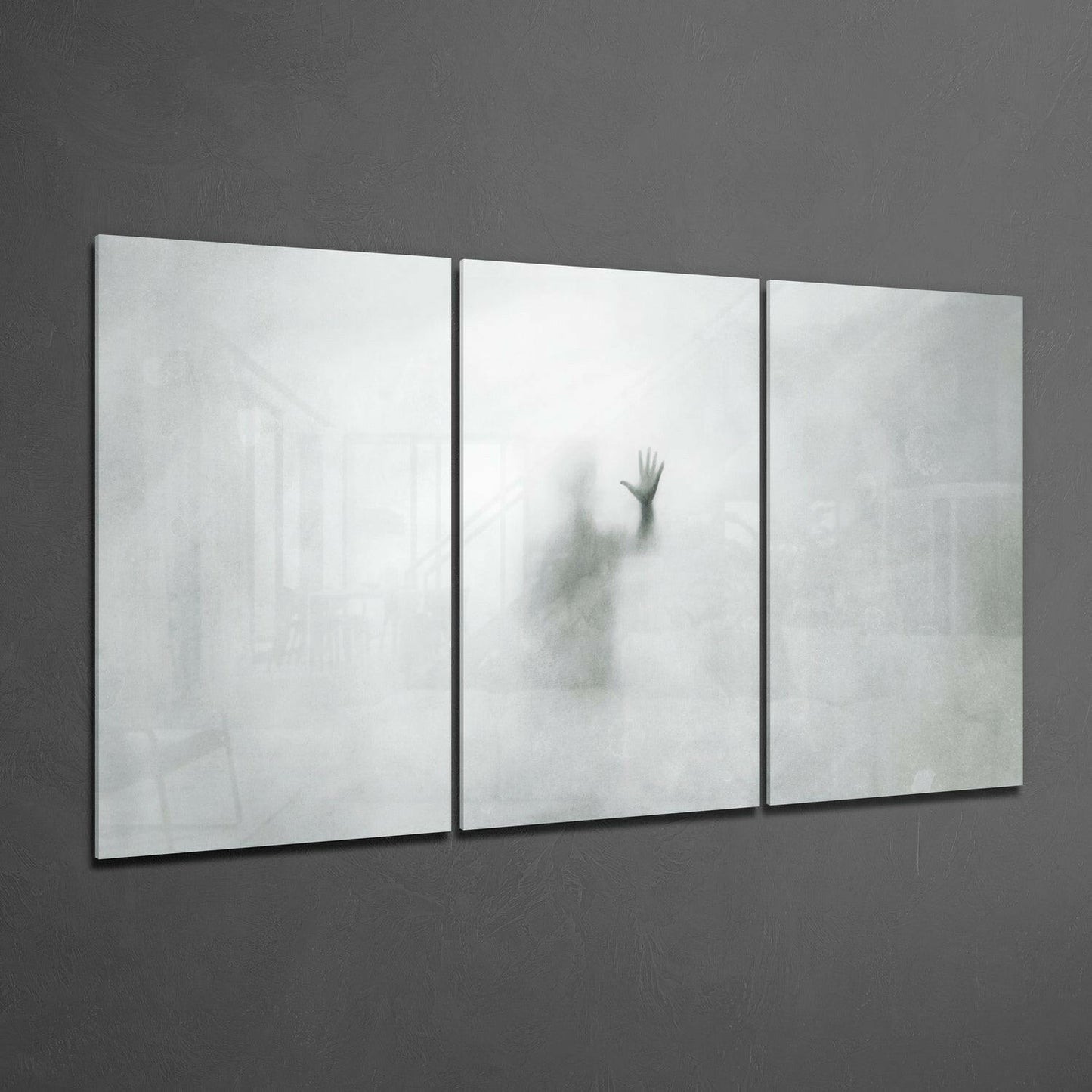 Three-panel frosted glass wall art displaying a blurred silhouette of a raised hand against white and gray tones.