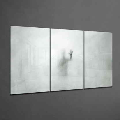 Three-panel frosted glass wall art displaying a blurred silhouette of a raised hand against white and gray tones.