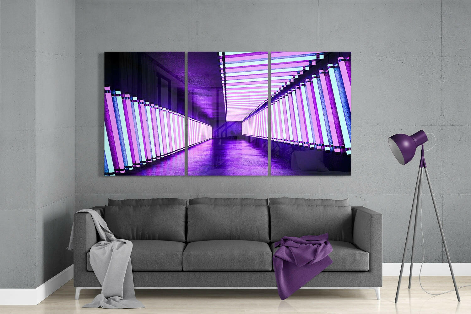 Three-panel purple neon corridor glass art displayed above gray sofa in modern living room with tripod lamp and throws.
