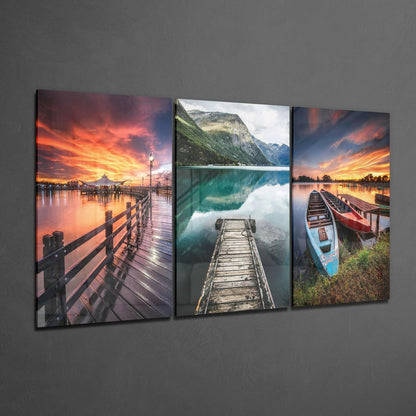 Three glass wall art panels featuring wooden piers and docks at sunset and lakeside locations with reflective water.