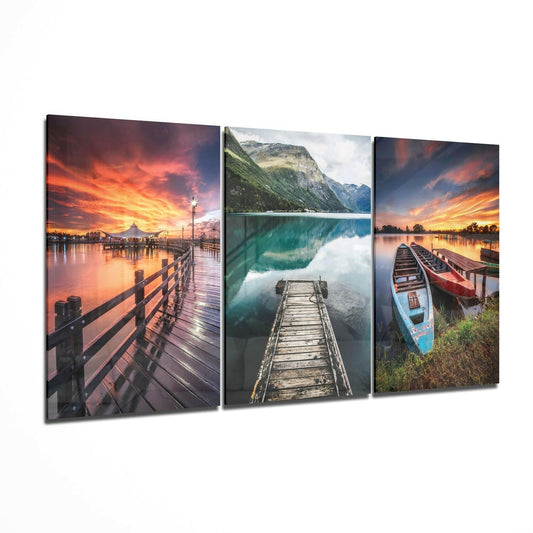 Three glass wall art panels displaying wooden piers and docks at sunset and lakeside locations with vibrant orange and turquoise tones.