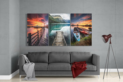 Three glass wall art panels displaying sunset piers and lakeside scenes hung above a gray sofa in a modern living room.
