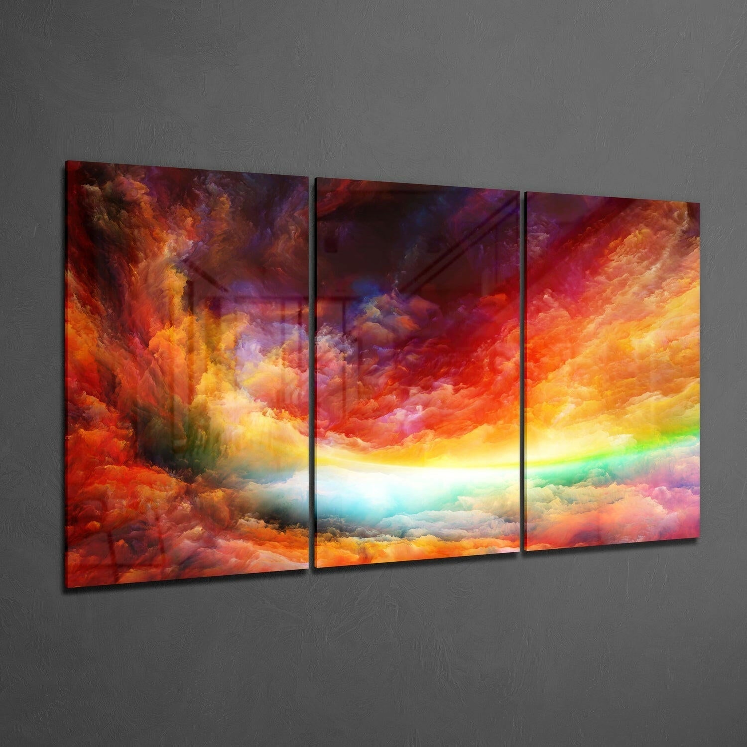 Three-panel glass wall art displaying vibrant red, orange, and yellow clouds with a bright central light source and rainbow gradient.