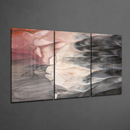 Three-panel glass wall art displaying abstract swirling layers in coral, cream, and charcoal tones mounted on gray wall.