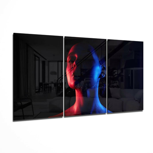 Three-panel glass wall art displaying a sculptural head split vertically in red and blue neon lighting against dark background.