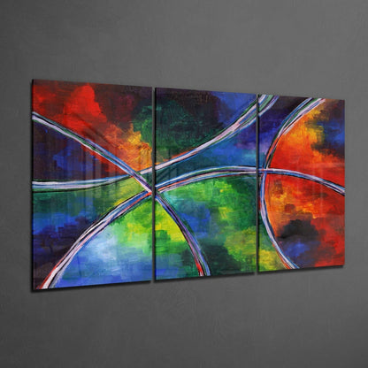 Three-panel abstract glass wall art featuring vibrant red, blue, green, and yellow sections divided by white curved lines, displayed on gray wall.