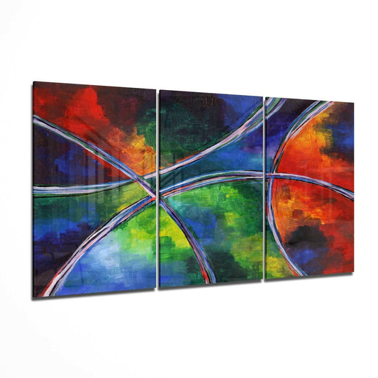 Three-panel abstract glass wall art with vibrant red, blue, green, and yellow flowing colors intersected by silver curved lines, displayed at an angle.