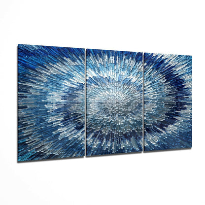 Three-panel blue glass wall art with radiating white and light blue streaks creating a burst effect from center outward.