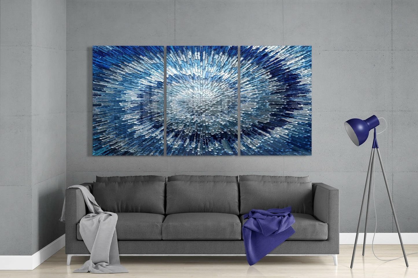 Three-panel blue textured glass wall art with radiant white center displayed above gray sofa in modern living room.