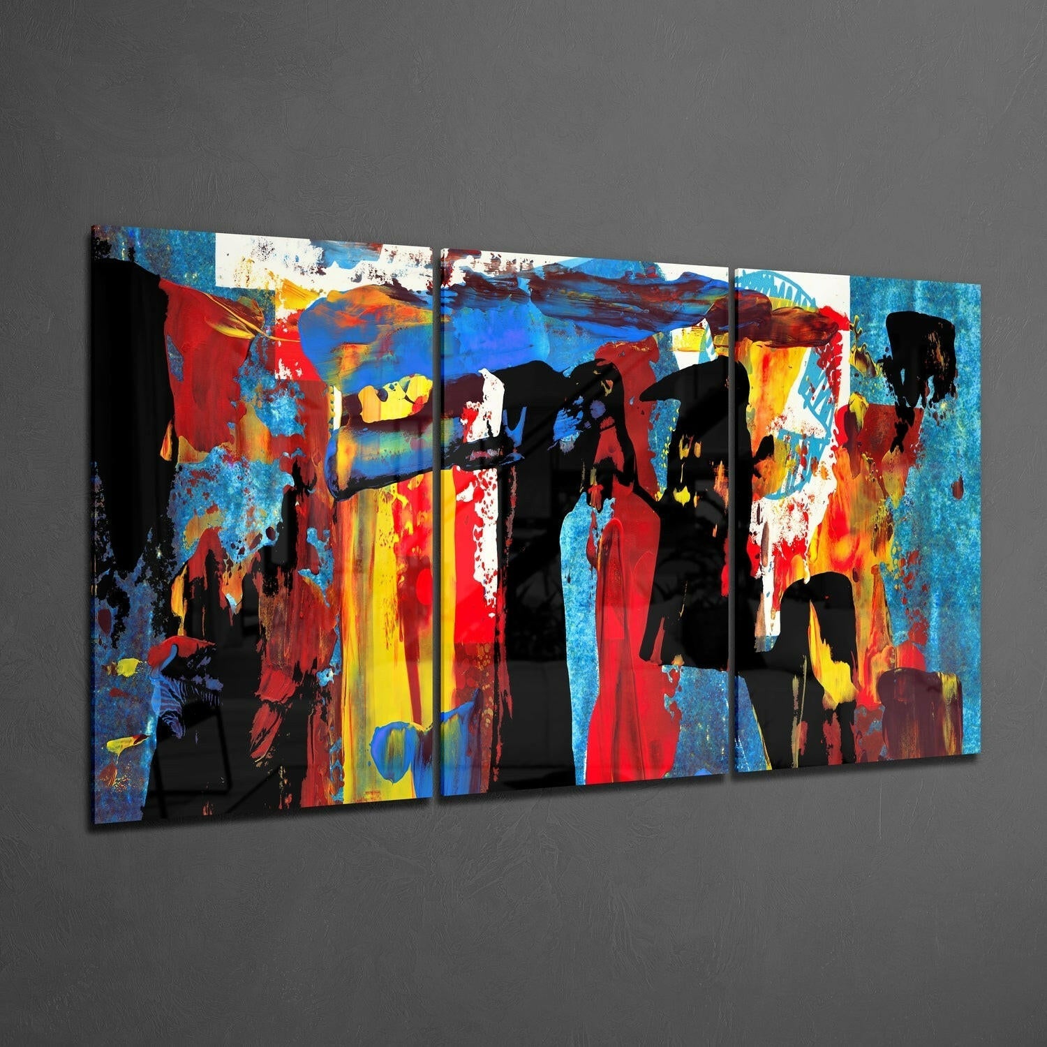 Multi-panel glass wall art featuring vibrant red, blue, yellow, and black abstract silhouettes against textured backgrounds, displayed at an angle.