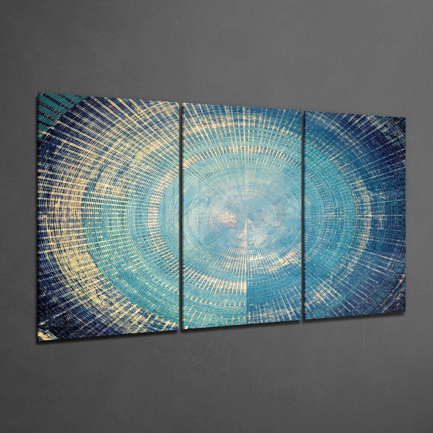 Three-panel textured glass wall art with concentric circular patterns in blue, teal, and gold tones displayed on gray wall.