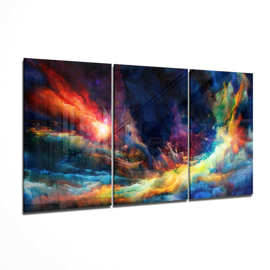 Three-panel glass wall art displaying a cosmic nebula scene with swirling clouds of red, orange, yellow, blue, and purple colors against a dark starry background.