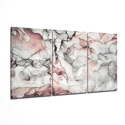 Three-panel glass art displaying abstract fluid ink patterns in mauve, pink, and gray tones on white background, angled perspective view.