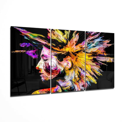 Three-panel glass art displaying an abstract colorful profile with vibrant yellow, pink, purple, and blue brushstrokes on black background.