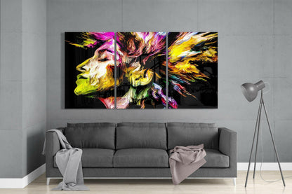 Colorful Peace glass art triptych displaying vibrant yellow, pink, and magenta profiles hung above gray sofa in minimalist interior.
