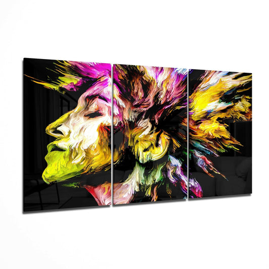 Three-panel glass art displaying an abstract profile with vibrant yellow, magenta, pink, and black brushstrokes on dark background.