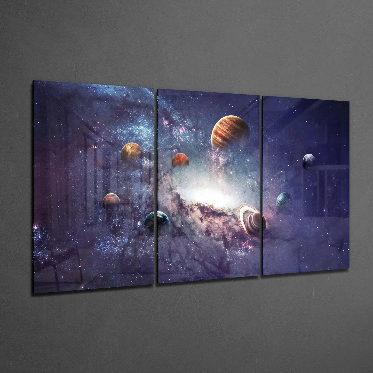 Three-panel glass art displaying planets and galaxy against deep purple starfield on gray wall.