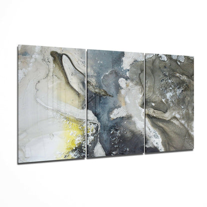 Three-panel abstract glass art with layered textures in white, gray, blue, and yellow tones displayed at an angle.