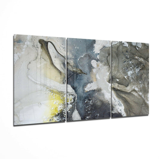 Three-panel abstract glass art with layered textures in white, gray, blue, and yellow tones displayed at an angle.