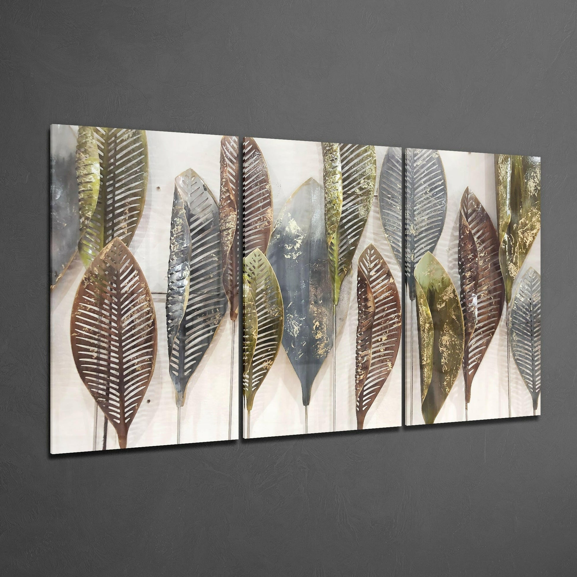 Multi-panel glass artwork displaying stylized leaves in brown, gold, and gray tones mounted on gray wall.