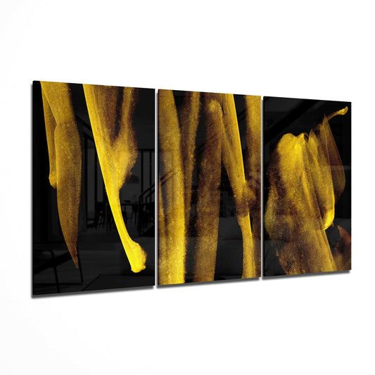 Three-panel triptych display of vertical gold and brown streaks flowing downward against black glass backgrounds, shown at an angle.