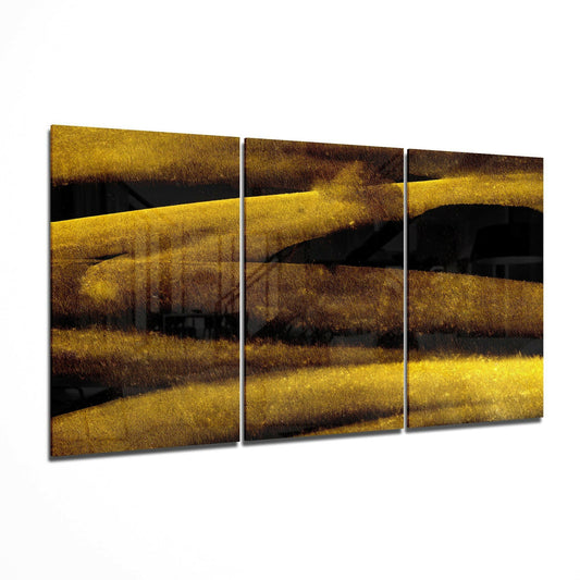 Three-panel abstract glass art displaying horizontal bands of gold, brown, and black colors with textured finish in perspective view.