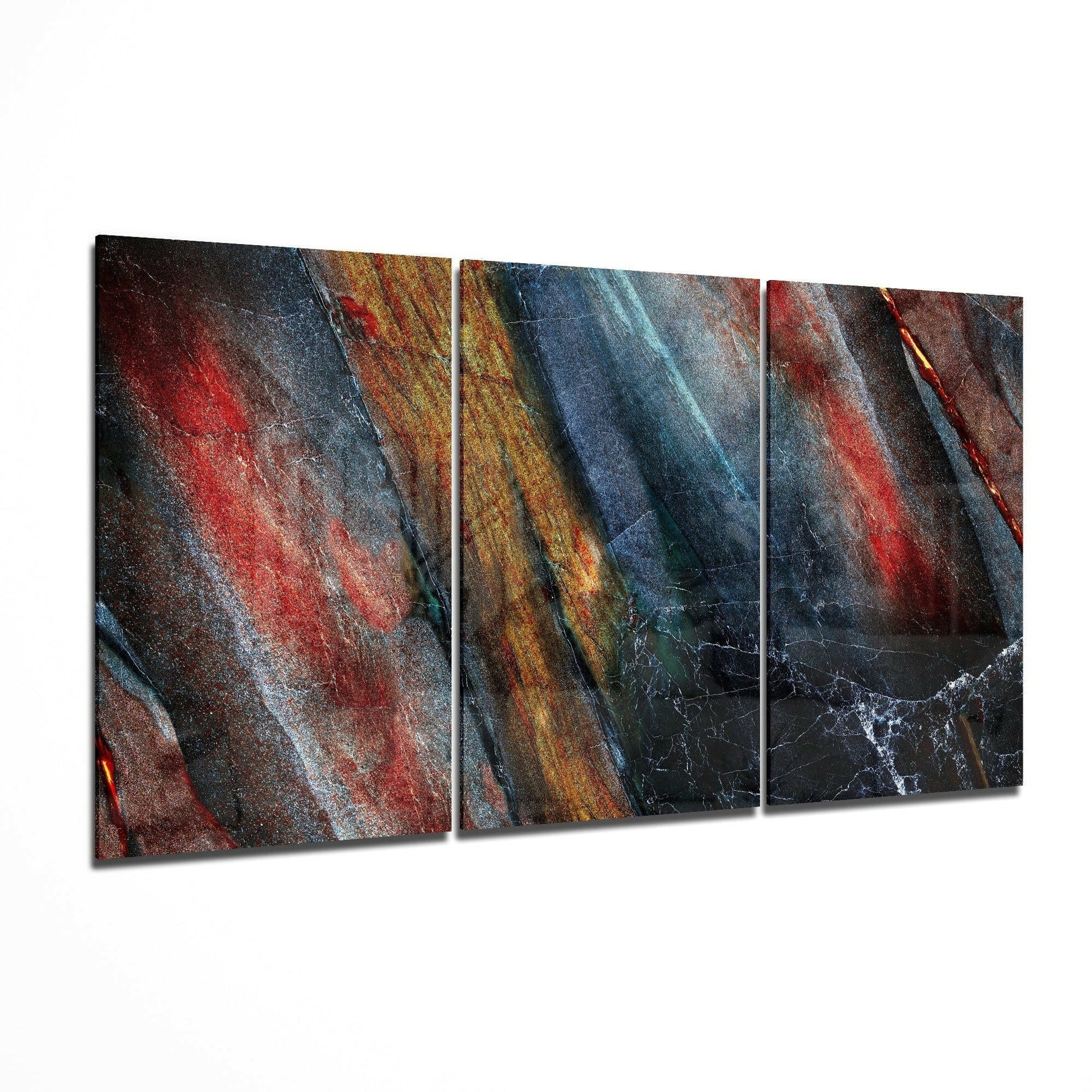 Three-panel glass art displaying layered diagonal stripes in red, blue, gold, and black with textured surfaces.