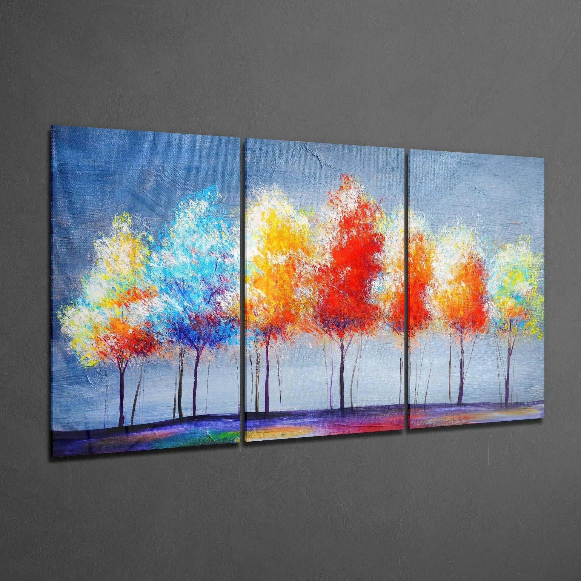 Three-panel glass art depicting colorful abstract trees with vibrant red, yellow, and blue foliage against a light blue sky and rainbow ground.