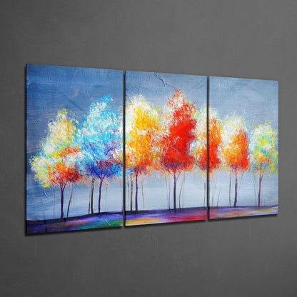 Three-panel glass art depicting colorful abstract trees with vibrant red, yellow, and blue foliage against a light blue sky and rainbow ground.