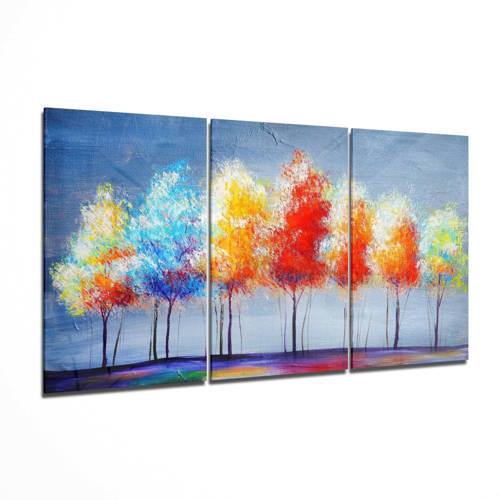 Three-panel glass art depicting vibrant colorful trees with red, yellow, and blue foliage against a blue sky and colorful ground.