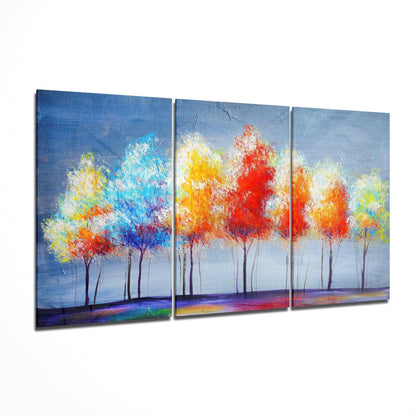 Three-panel glass art depicting vibrant colorful trees with red, yellow, and blue foliage against a blue sky and colorful ground.