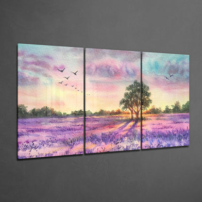 Three-panel glass art depicting a lavender field at sunset with a solitary tree and flying birds in purple, pink, and gold tones.