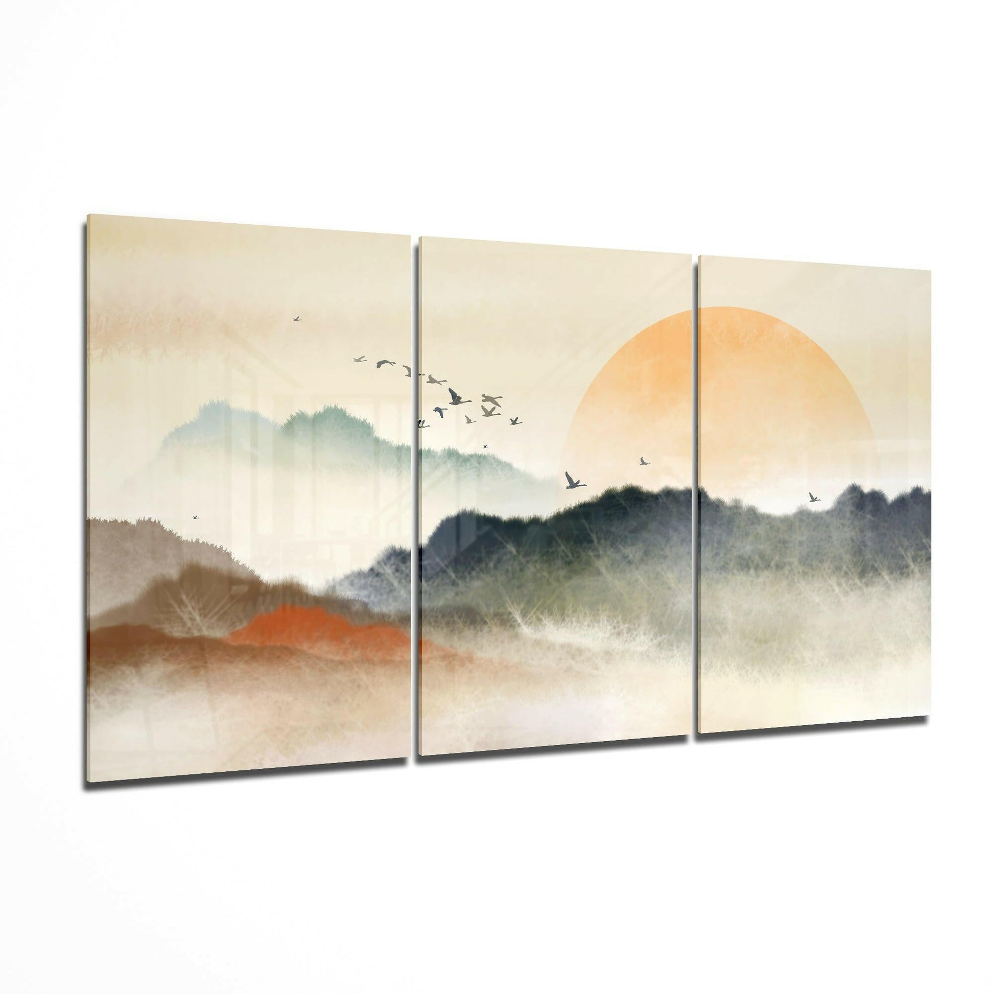 Three-panel glass art depicting misty mountains with golden sun, flying birds, and layered landscape in soft earth tones.