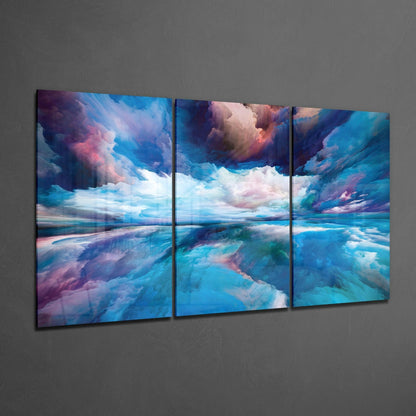Three-panel glass art displaying a dreamlike seascape with turquoise water, pink and purple clouds, and reflective horizon mounted on gray wall.