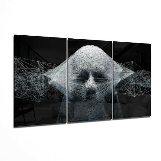Three-panel black glass wall art displaying a monochromatic string-rendered face with geometric wire patterns extending outward against a dark background.