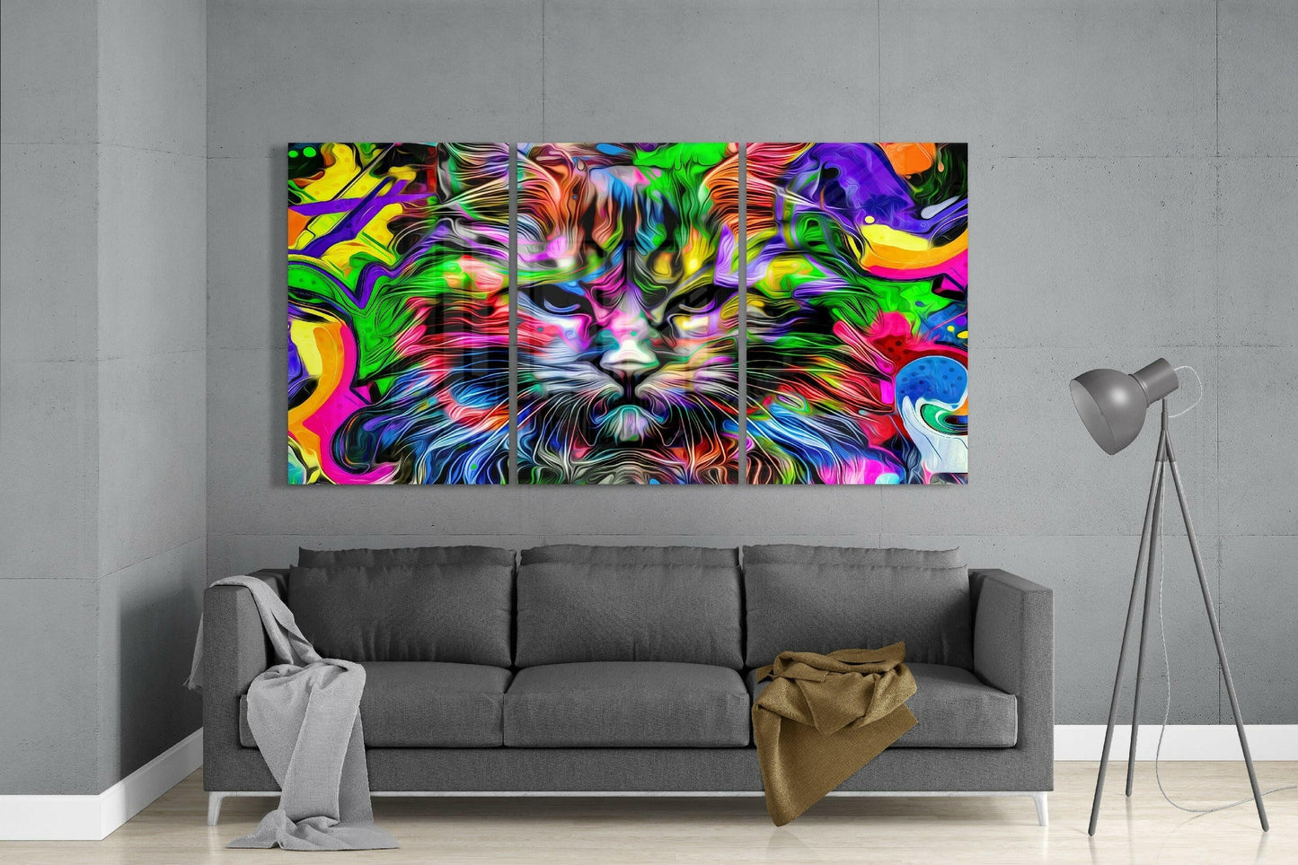 Vibrant three-panel colorful cat glass art display mounted above gray sofa in modern living room interior.