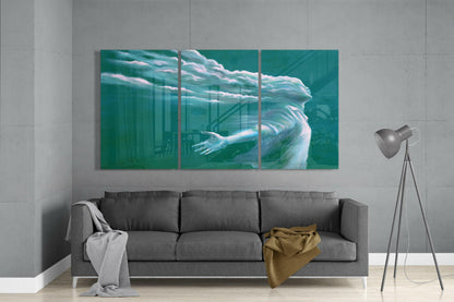 Three-panel turquoise glass art depicting an ethereal figure with flowing hair and outstretched arm, displayed above gray sofa.