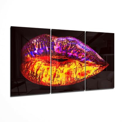 Vibrant lip-shaped glass art with yellow, red, orange, and purple iridescent coloring displayed as three-panel triptych.