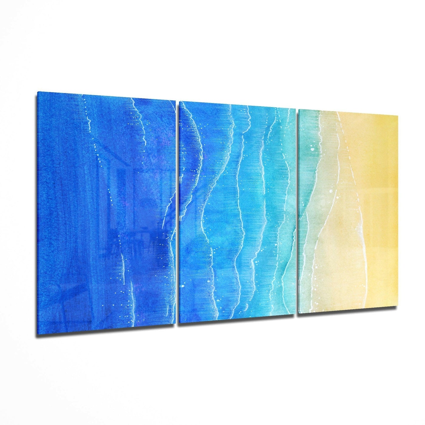 Three-panel canvas triptych depicting aerial view of ocean waves meeting sandy beach in gradient colors from deep blue to yellow.