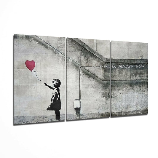 Three-panel canvas triptych displaying Banksy-style stencil art of silhouetted child reaching toward red heart balloon above concrete wall with "There Is Always Hope" text.