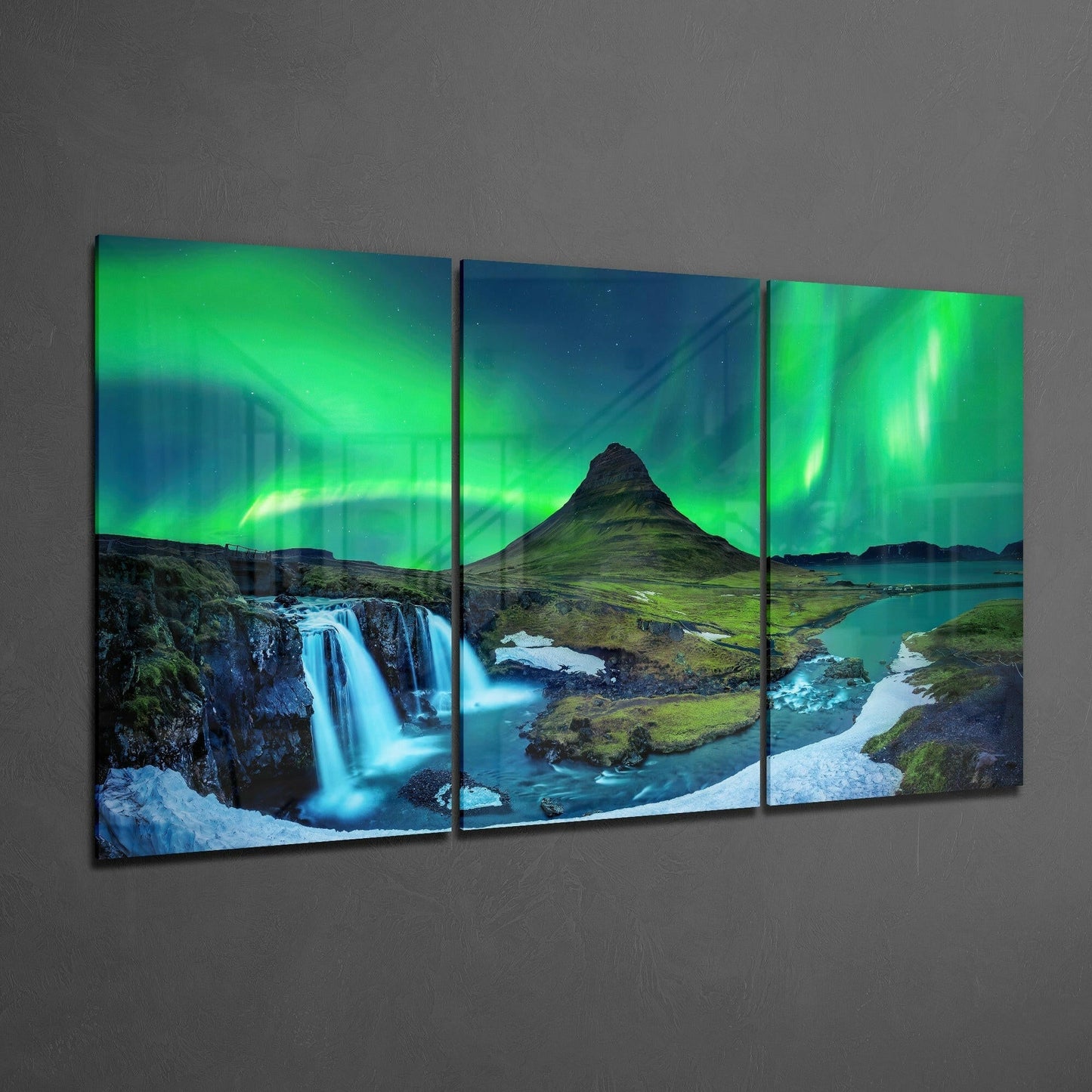 Three-panel glass art displaying Icelandic landscape with green aurora borealis, waterfall, mountain, and turquoise water.
