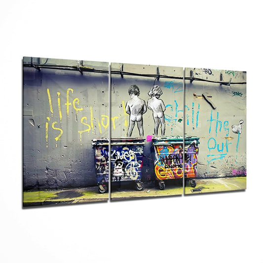 Triptych canvas print displaying stenciled children figures with yellow and blue text reading "life is short" and "enjoy" above colorful graffitied trash bins on weathered concrete wall.