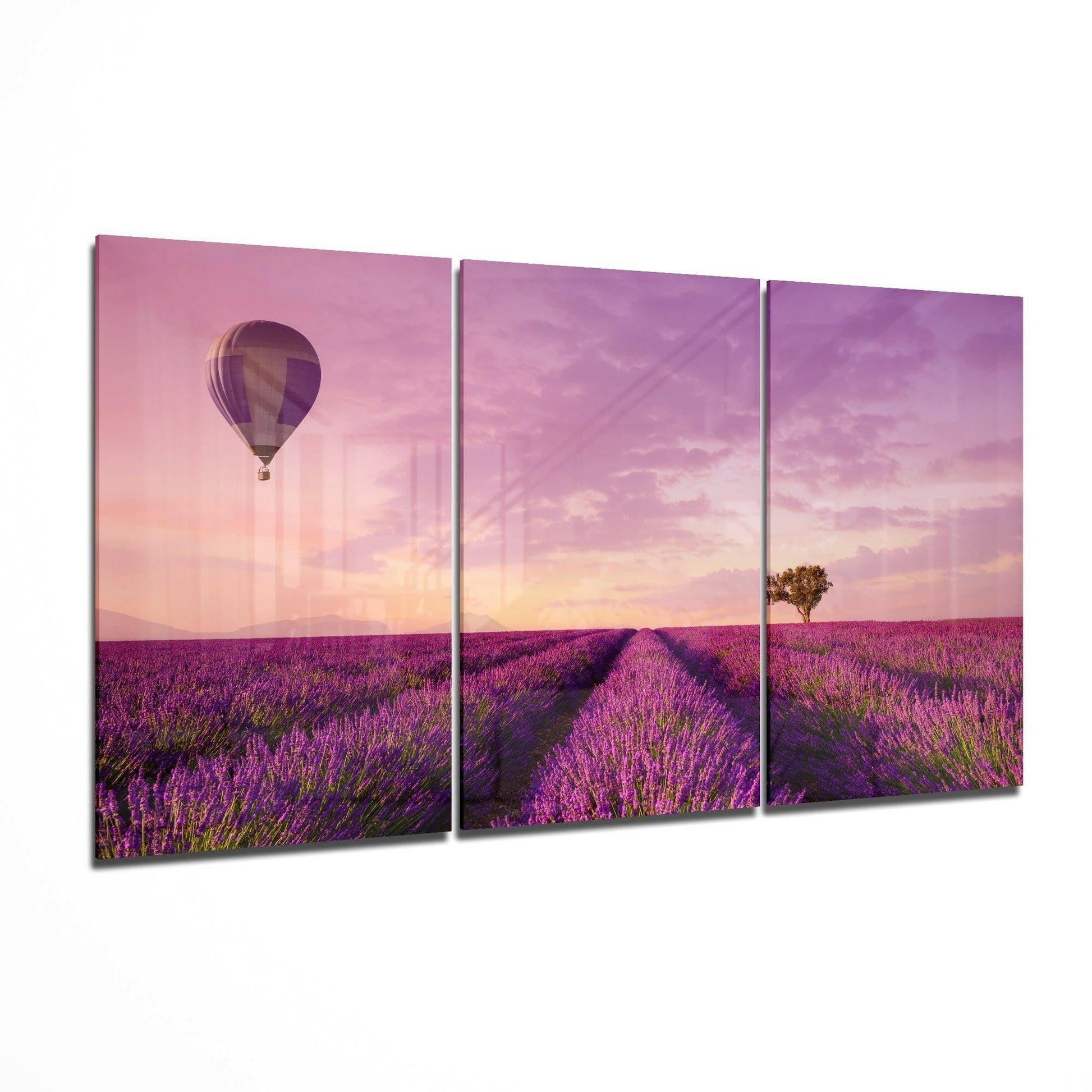 Three-panel glass art display showing a hot air balloon over a purple lavender field at sunset with a solitary tree on the horizon.