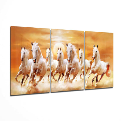 Three-panel glass art depicting seven white horses galloping through golden clouds at sunset.